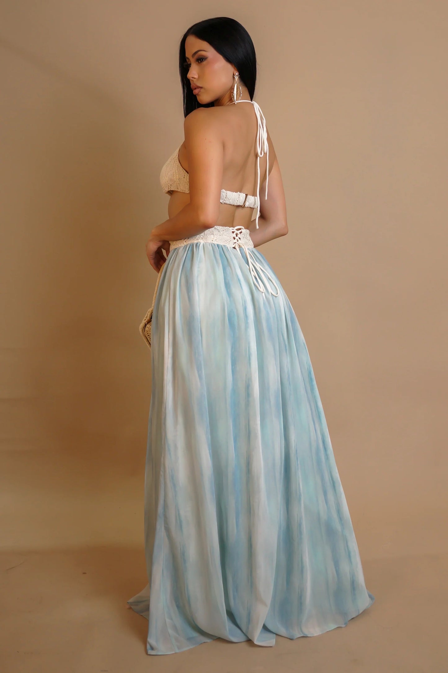 Woman wearing blue crochet maxi dress with wooden rings