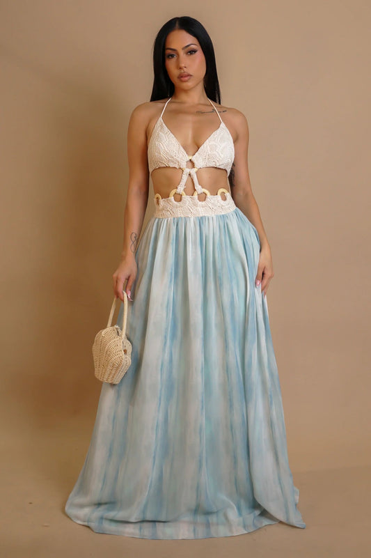 Woman wearing blue crochet maxi dress with wooden rings

